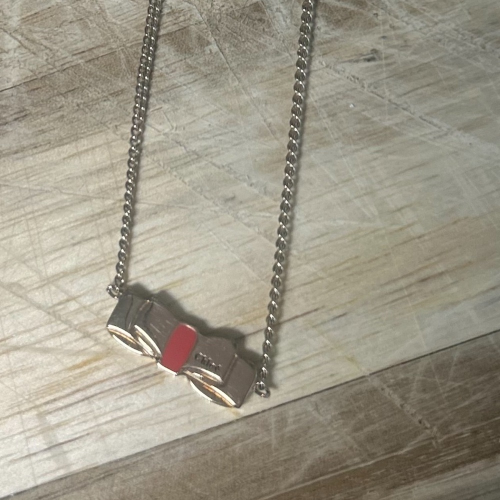 Chloe Gold tone Necklace with Red Bow Accent